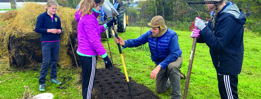 French Broad River Academy volunteers help seed garlic